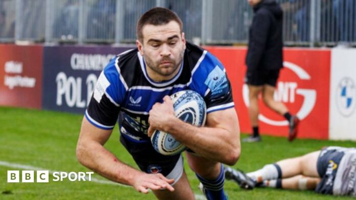 Will Muir skips over a tackle to score a try for Bath