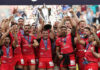 Antoine Dupont lifts the 2024 European Rugby Champions Cup at the Tottenham Hotspur Stadium.