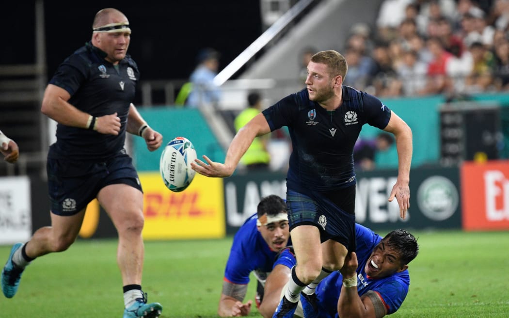 Scotland's fly-half Finn Russell (R) set up their first two tries.