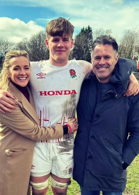 A woman and man embracing their son in a muddy rugby uniform.