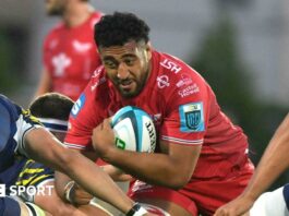Carwyn Tuipulotu goes into a tackle with the ball during a game for Scarlets last season