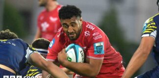 Carwyn Tuipulotu goes into a tackle with the ball during a game for Scarlets last season