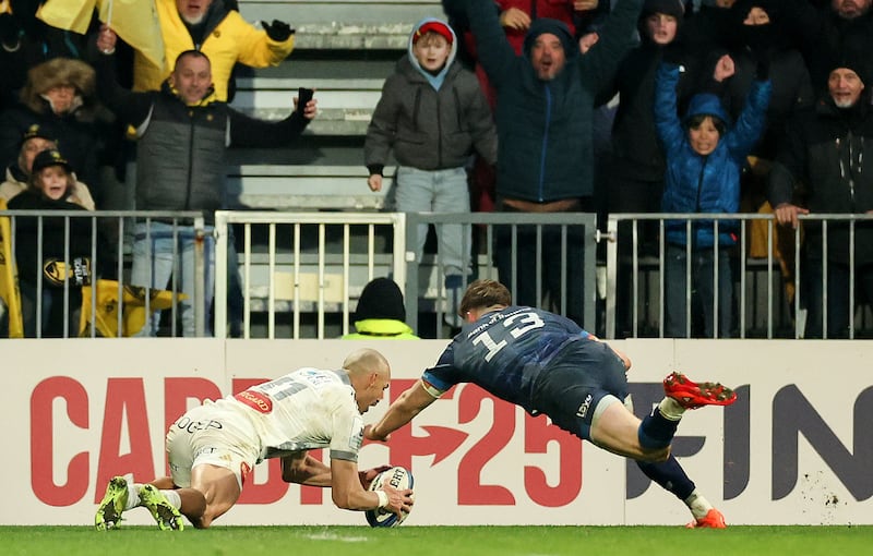 La Rochelle's Dillyn Leyds scores a try despite the attempted tackle of Leinster's Garry Ringrose. Photograph: James Crombie/Inpho