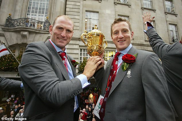 Lawrence Dallaglio and Will Greenwood hold the Webb Ellis Cup during the England Rugby World Cup team victory parade December 8, 2003 in London