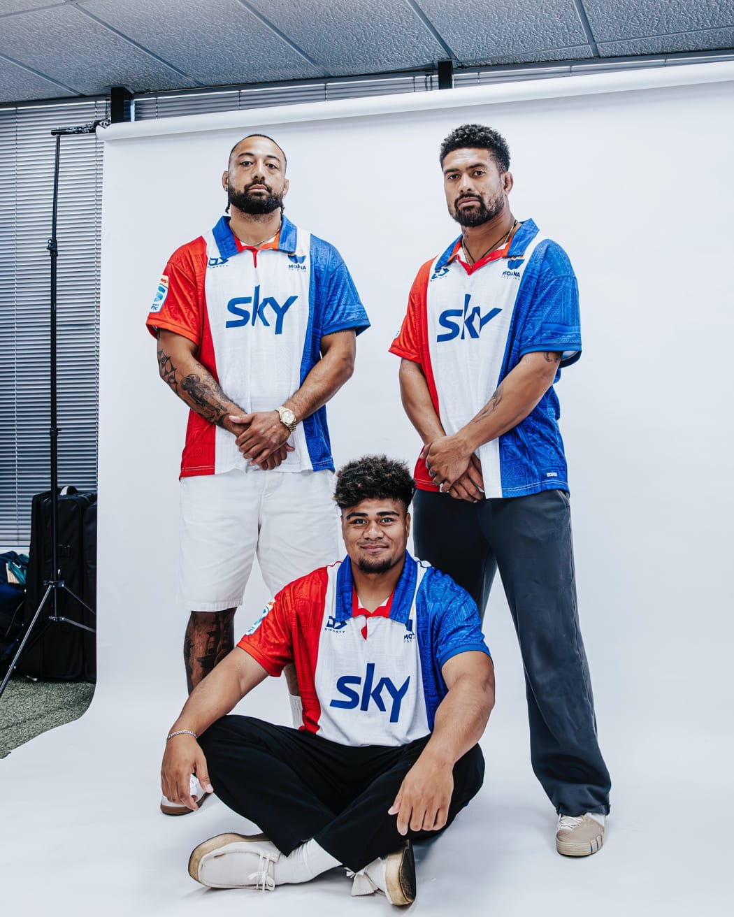 Ardie Savea, right, Pone Fa’amausili,left, and Lotu Inisi, sitting front, display the new Moana Pasifika heritage jersey, a replica of the old Pacific Islanders jersey. Photo: Moana Pasifika