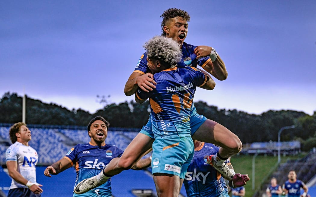 Fine Inisi of Moana Pasifika celebrates his try with team.