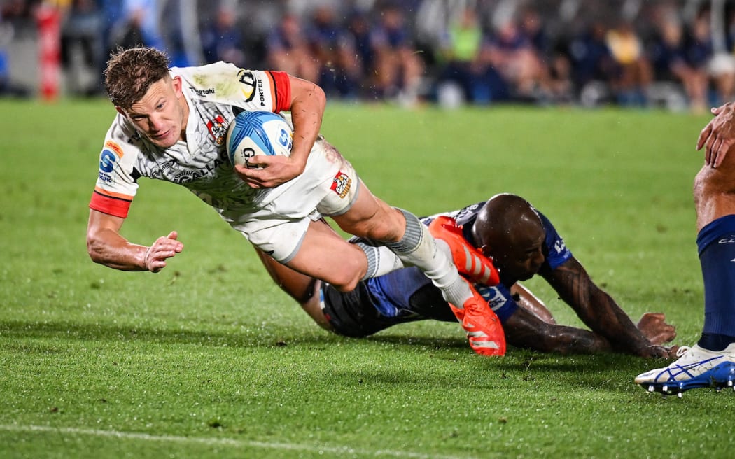 Damian McKenzie of the Chiefs dives to score a try.