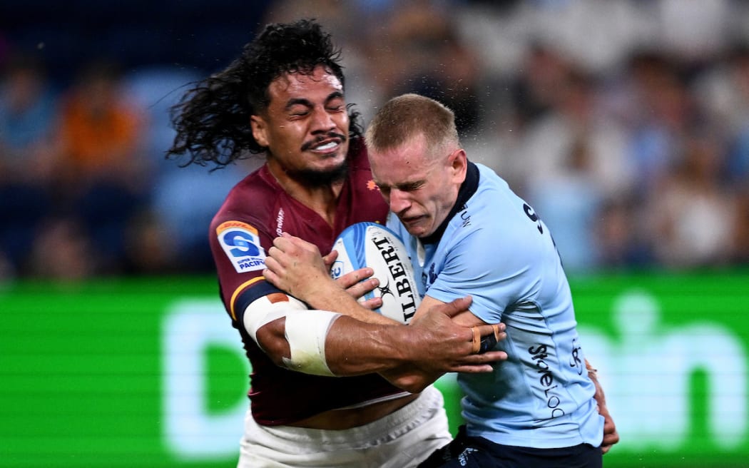 Max Jorgensen of the Waratahs is tackled by Tanielu Tele'a of the Highlanders.