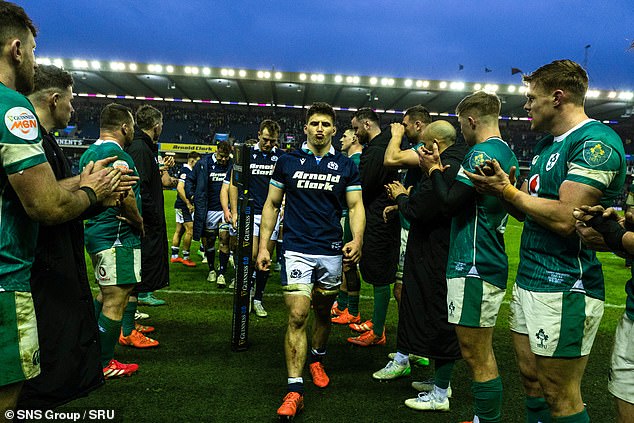 Darge leads his battered and bruised team-mates past the Irish guard of honour at full-time