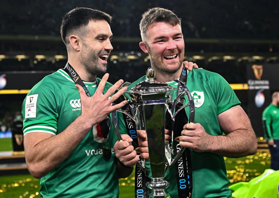 Peter O'Mahony and Conor Murray holding the Guinness Six Nations Rugby Championship trophy.