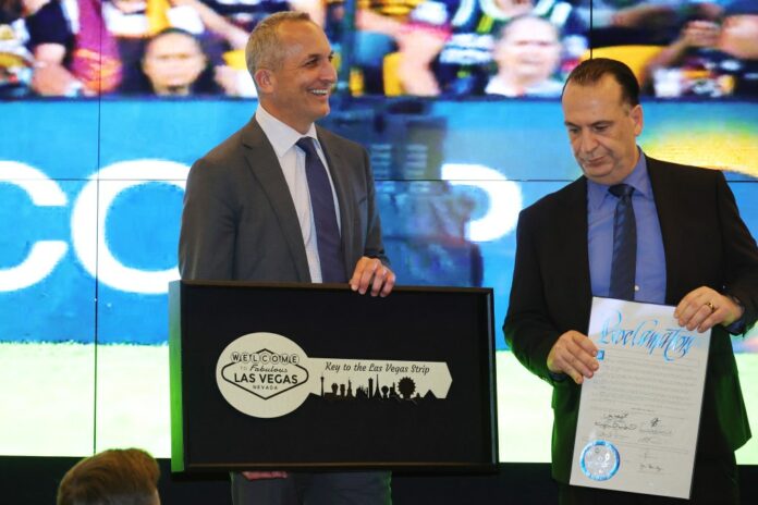 Left to right: National Rugby League CEO Andrew Abdo and Chairman of the Australian Rugby League Commission Peter V'landys are presented with a ceremonial key to the Las Vegas Strip.