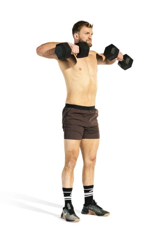 individual demonstrating a shoulder exercise with dumbbells