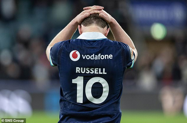 Finn Russell has his head in his hands after Scotland suffered their narrow defeat by England