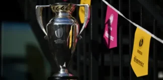 Getty Images A photo of a shiny silver trophy. In the background there are pink and yellow bunting to represent the women's rugby world cup