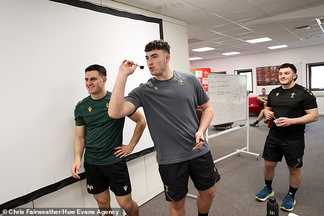 Lock Luke Evans lines up a darts throw as the young Wales stars enjoy a bit of down time