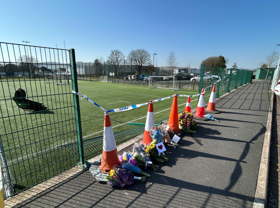 Floral tributes and messages of condolence at a rugby club following a fatal accident.